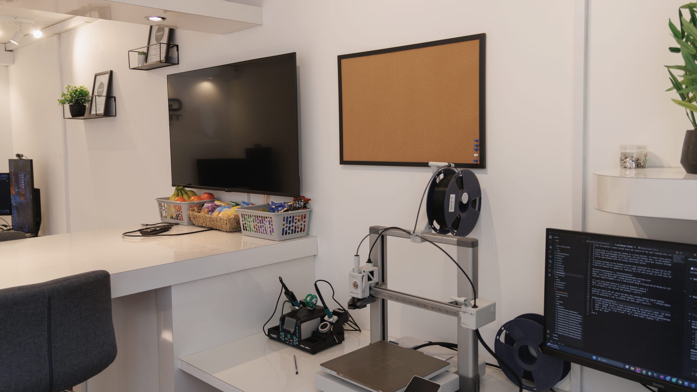 The bench in the office: printer, iron and a screen of firmware. Prototypes start here.