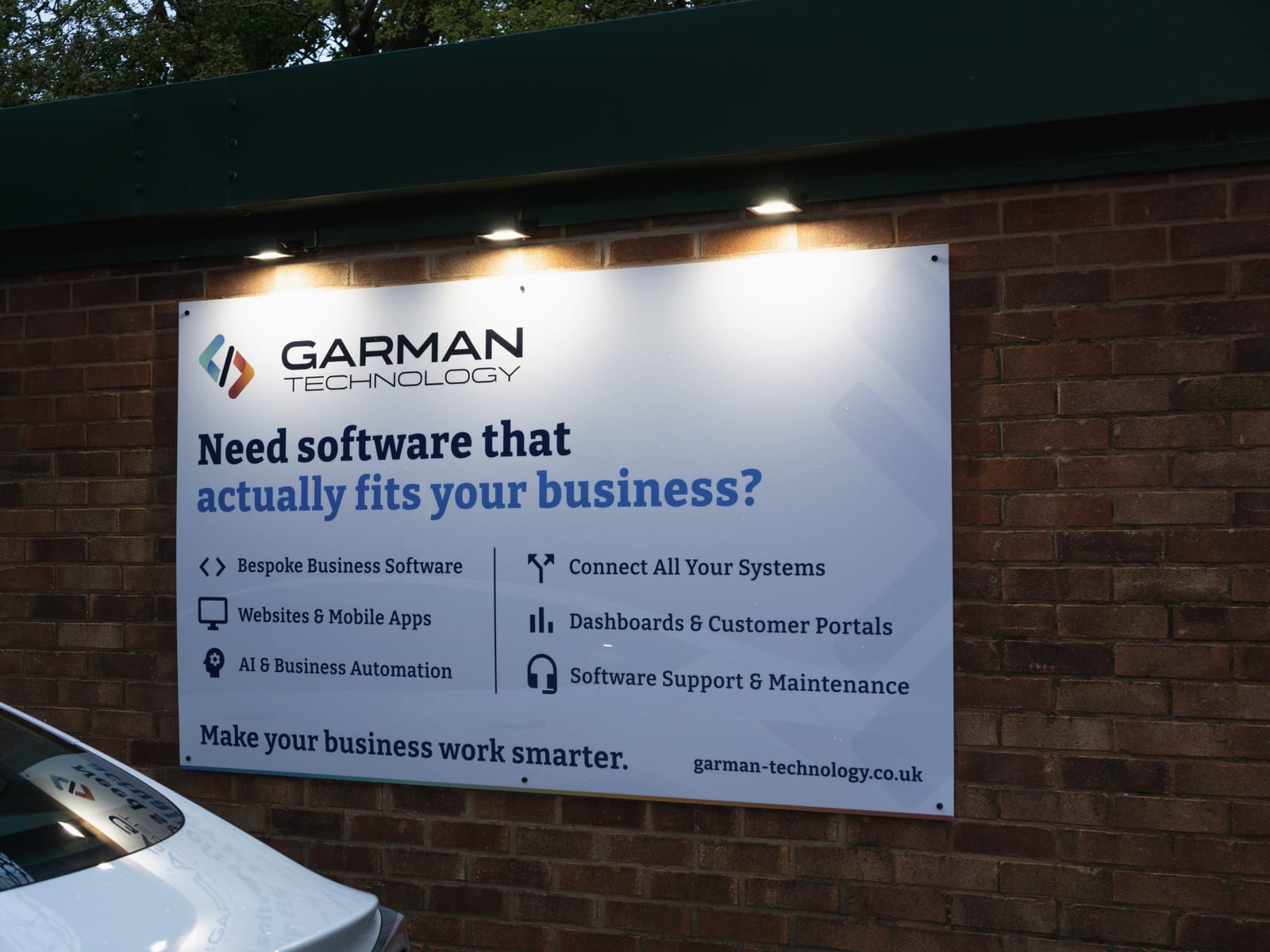 The Garman Technology sign lit at dusk